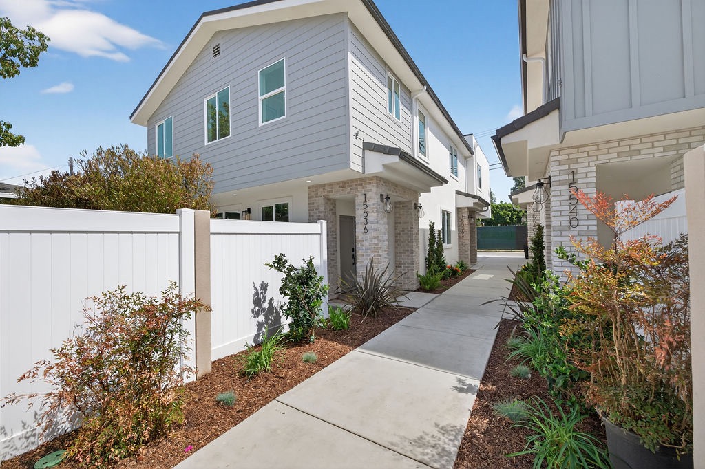 Daytime walkway view of Plan B homes at 15536 and 15540