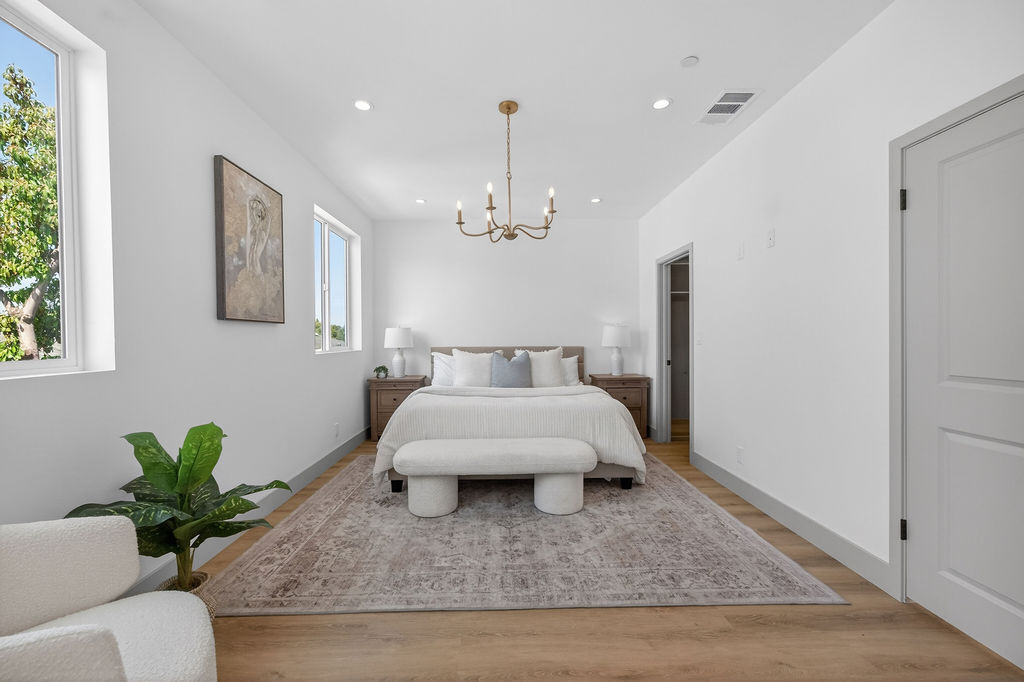 Plan B primary bedroom with chandelier